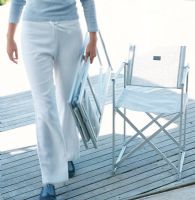 Woman carrying chair, low section