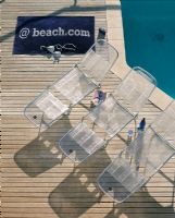 Overhead view of lounge chairs next to a pool