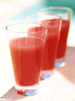 Close-up of three glasses of juice
