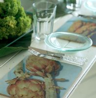 Table settings with vegetable print place mats