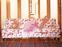 Woman laying on a floral pattern sofa