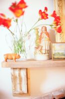 Flower vase and statue on shelf