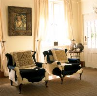 Two cowhide covered armchairs