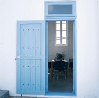 Home exterior with open blue painted door