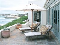 Patio with chaise lounge and a view of the ocean