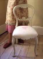 Woman standing by chair