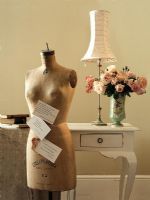 Mannequin and flower vase on side table