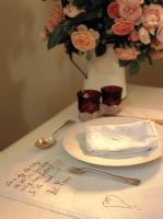 Detail of table setting and a bouquet of roses