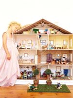 Girl playing with doll house