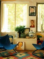 Living room with blue canvas chairs and portraits