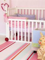 Toddlers bedroom with crib and toys
