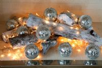 Fairy lights and Christmas decorations in fireplace
