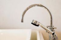 Detail of a modern chrome faucet