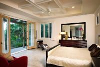 Interior of bedroom with french doors open to backyard