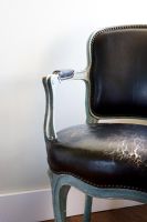 Black Antique leather chair with worn seat