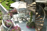Contemporary patio with spiral staircase