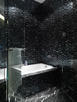 Black tiled bathroom and bathtub