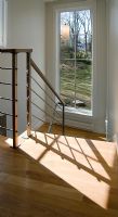 Shadow from handrail on hardwood floor
