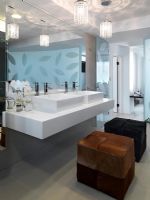 Modern bathroom with double sinks and ottomans