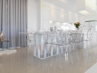 Low angle modern dining table with clear plastic chairs