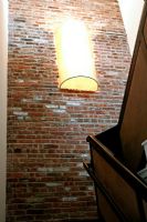 Staircase with exposed brick wall