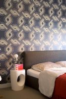 Modern bedroom with patterned wallpaper 