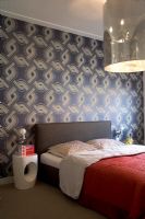 Modern bedroom with patterned wallpaper 