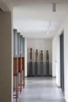 Modern hallway with wooden sculptures