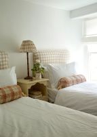 Twin beds with brown check headboard
