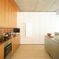 Modern kitchen with a wall of hidden cabinets