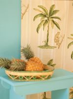 Pineapples in basket on side table