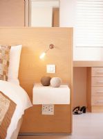 Bedside table with candles and a lamp