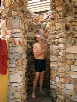 Man bathing in a stone shower