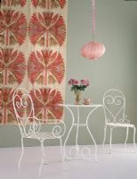Table and chairs with hanging lamp and fabric