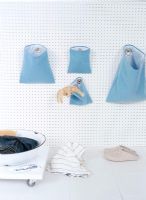 Blue laundry bags hanging on a wall