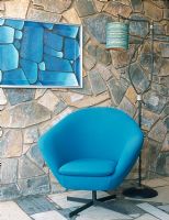 Stone walled living room with blue armchair