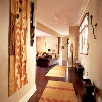 An African corridor with wooden flooring and rugs
