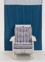 Blue and white striped chair against a blue background