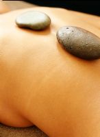 Woman receiving hot stone therapy