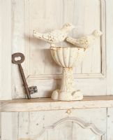 Key and sculpture on shelf