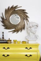 Accessories on yellow chest of drawers 