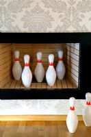 Collection of bowling pins in fireplace 