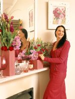 Woman arranging a bouquet on a mantelpiece