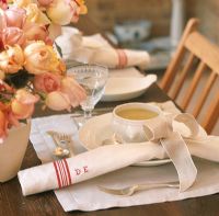 Close-up of table setting and a bouquet of roses