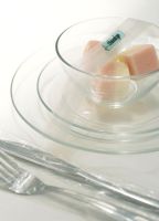 Sugar cubes in glass bowl with fork and knife, close-up