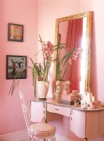 View of flowers and mirror on dressing table