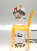 Two transparent chairs with flowers