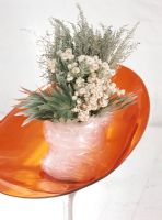 Plastic wrapped bouquet of flowers on an orange chair