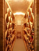 View of wine bottles on shelf in wine cellar