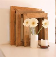 Wooden picture frames with flowers in vase